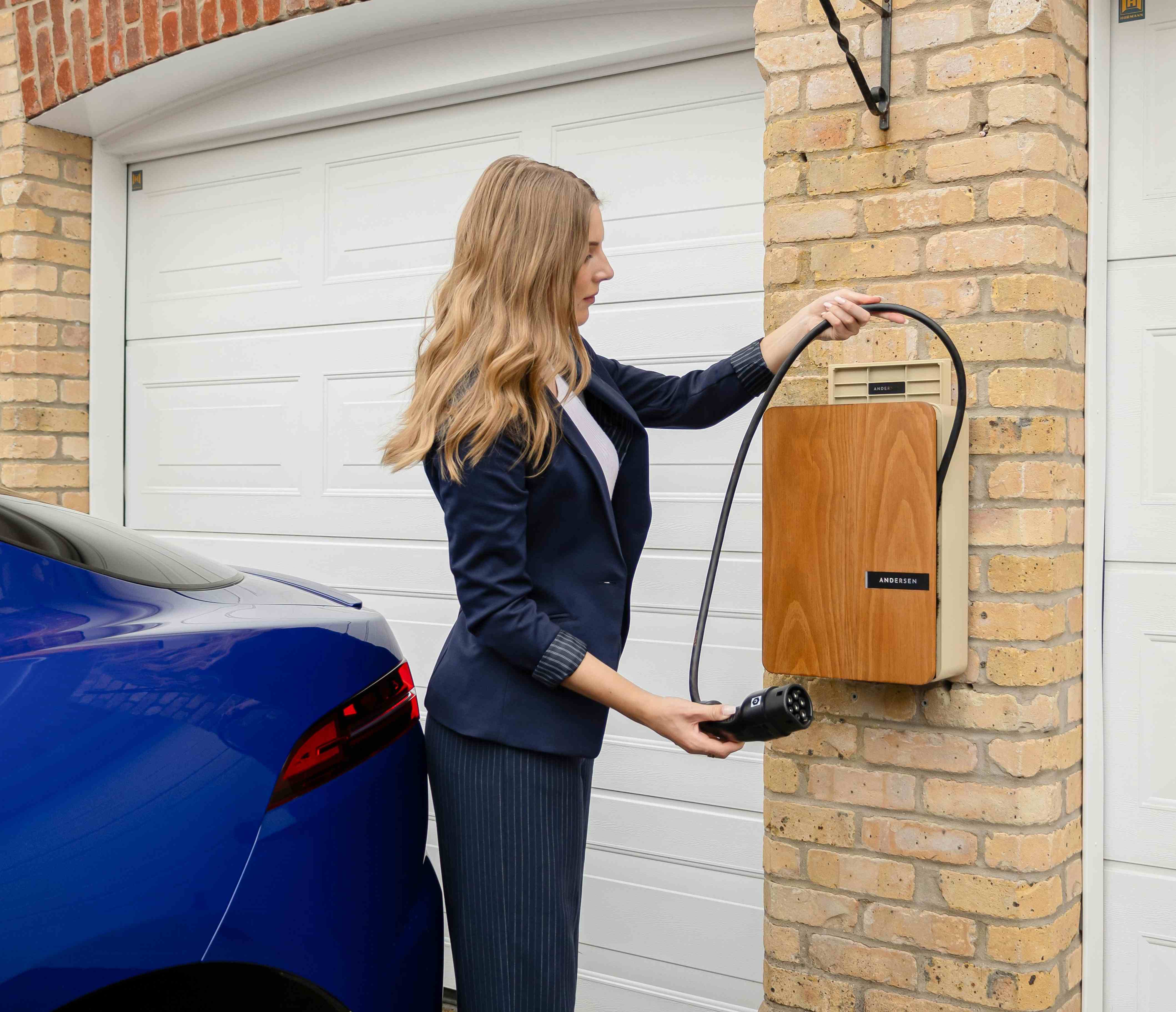Home EV charger in use outside a residential garage
